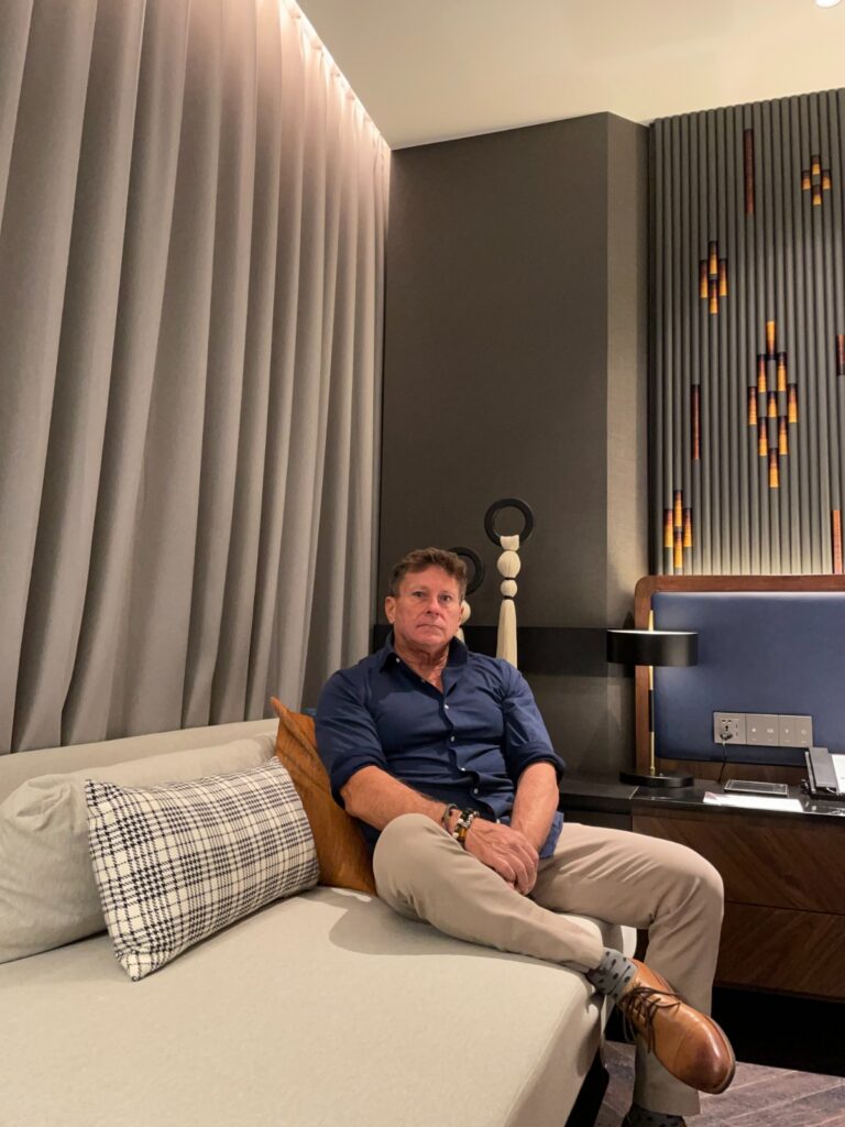 The author of Hotel Loyalty Points, seated in a hotel room