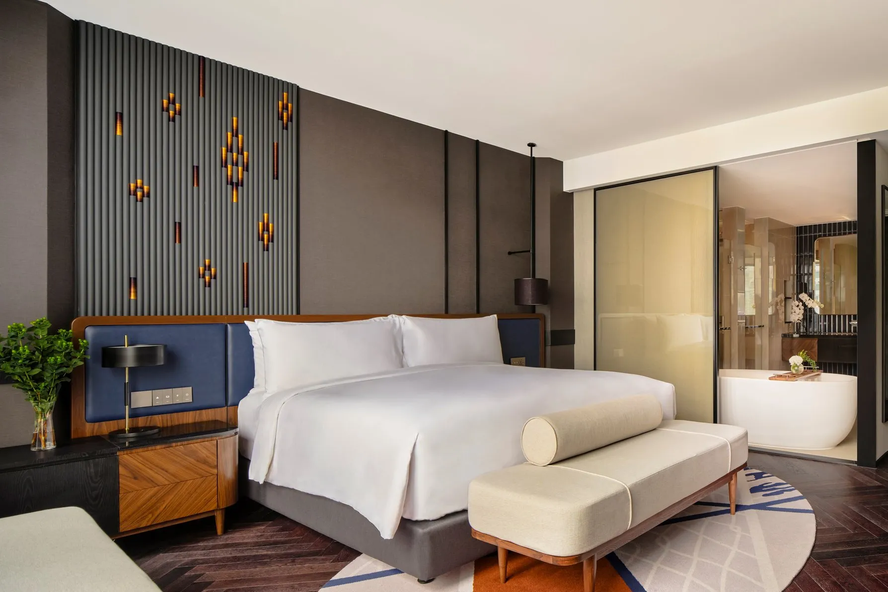 King room at InterContinental Bangkok Sukhumvit, bench seat at the foot of the bed and the bath beyond