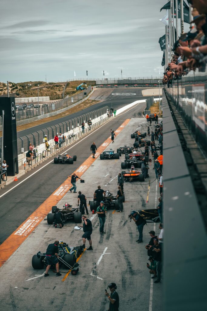 Formula 1 cars and crews in the pit lane on a race weekend